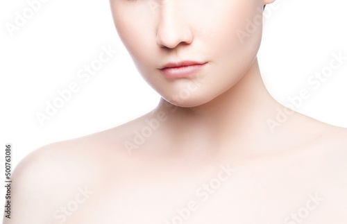 Close-up lips and shoulders of young caucasian woman with natural make-up, perfect skin isolated on white. Studio portrait.