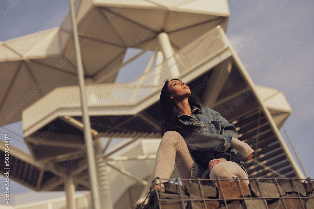 Wunderschöne Frau in Anzug und Jeans an Terrassen Aussichts Plattform im Sonnen Untergang Luxus