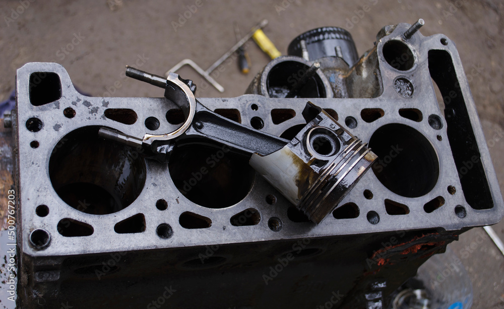 Fototapeta premium An auto mechanic is working on a car engine in a mechanics garage. Repair service. authentic close-up shot. VAZ 2106