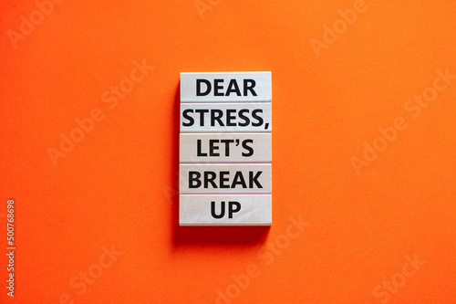 Stress break up symbol. Concept words Dear stress let is break up on wooden blocks. Beautiful orange table orange background. Business motivational stress break up concept. Copy space.