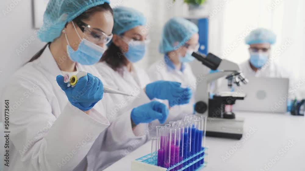 a team of multinational laboratory technicians conducts medical research a team of multinational laboratory technicians conducts medical research