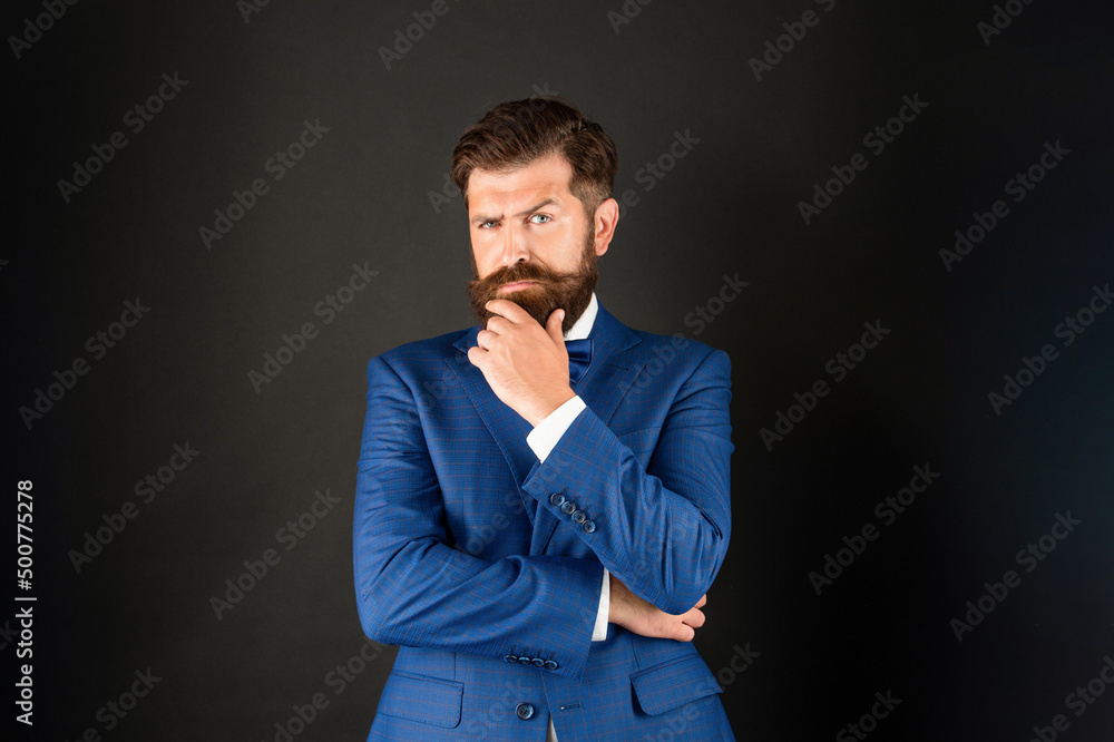 pondering serious man in tuxedo bow tie. waiter in formalwear on black background. formal fashion. pondering serious man in tuxedo bow tie. waiter in formalwear on black background. formal fashion.