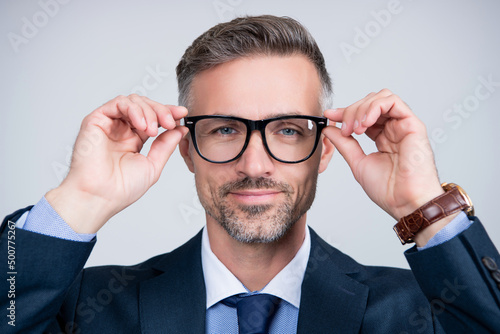 cheerful mature businessman in businesslike suit and glasses