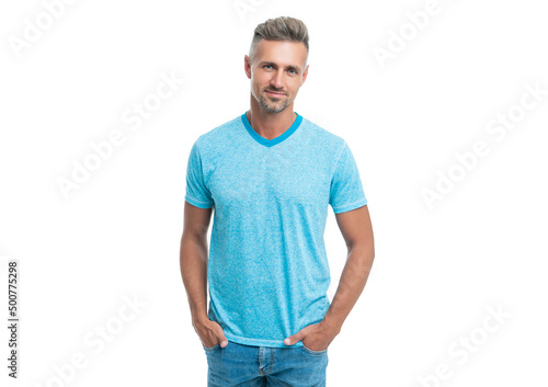 Happy handsome caucasian guy smiling in casual style holding hands in pockets isolated on white