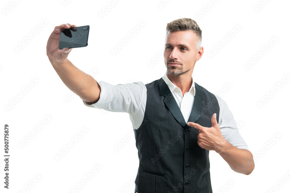 Serious professional man making video call with cellphone pointing finger isolated on white Serious professional man making video call with cellphone pointing finger isolated on white