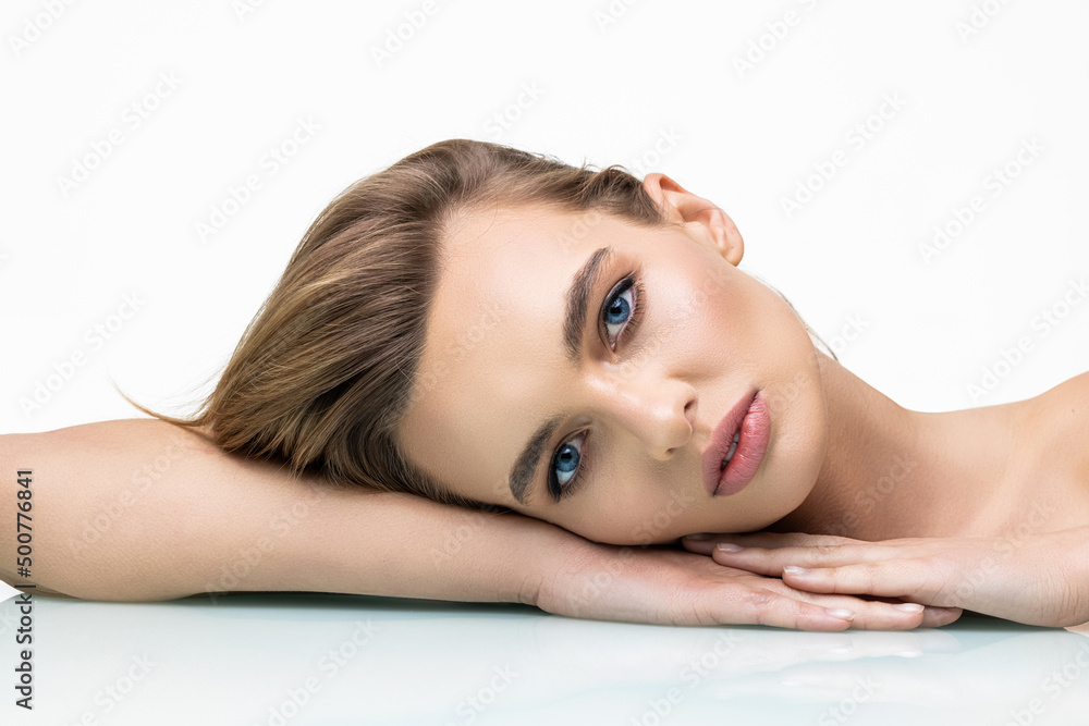 Beauty portrait of a smiling woman looking at camera on a white background Beauty portrait of a smiling woman looking at camera on a white background