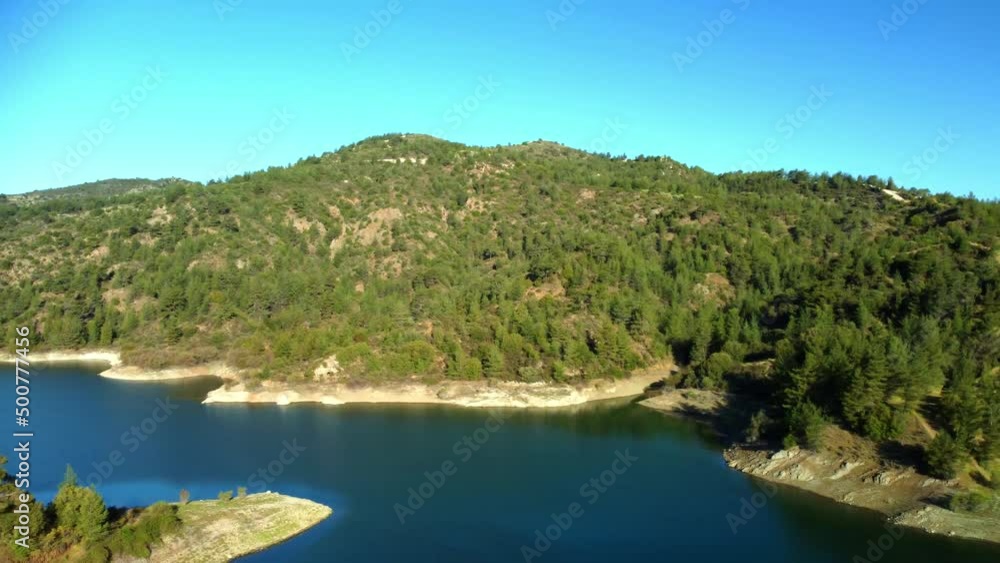 Blue lake in the Troodos mountains in the rays of the sun in the spring .Cyprus island. Aerial view.