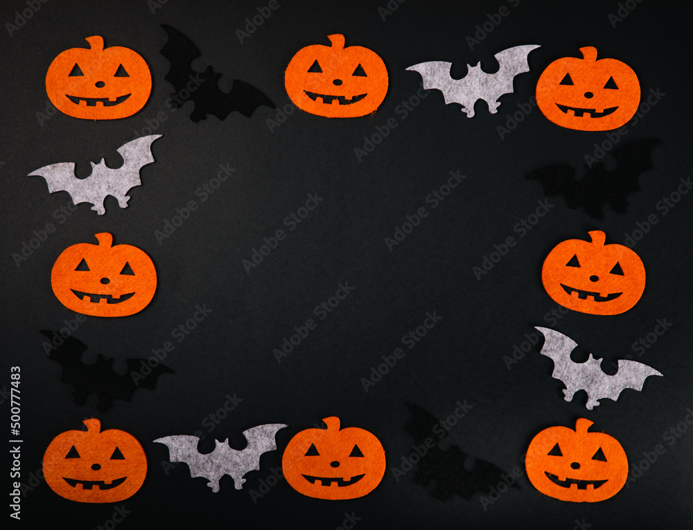 Frame of figures of orange pumpkins and bats on a black background. DIY Halloween decor.Holiday card.Halloween holiday concept.Place for copy.Place for text.Top view. Frame of figures of orange pumpkins and bats on a black background. DIY Halloween decor.Holiday card.Halloween holiday concept.Place for copy.Place for text.Top view.