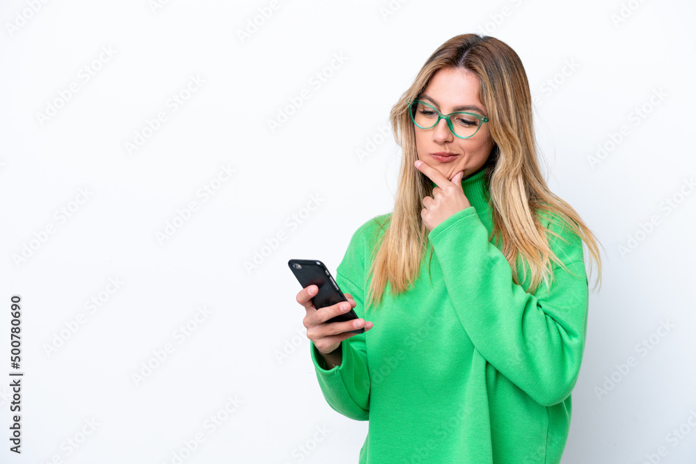 Young Uruguayan woman isolated on white background thinking and sending a message Young Uruguayan woman isolated on white background thinking and sending a message
