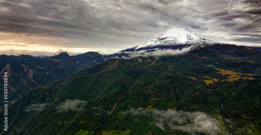 Antisana volcano in Ecuador, view from village Papallacta, snow on the top and green forests around, landscape photography, stratovolcano
