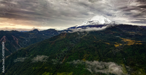 Antisana volcano in Ecuador, view from village Papallacta, snow on the top and green forests around, landscape photography, stratovolcano