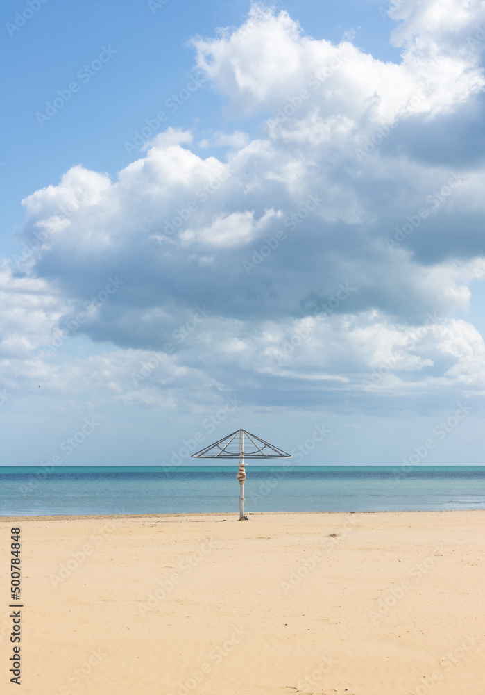 umbrella on a desert cloudy beach