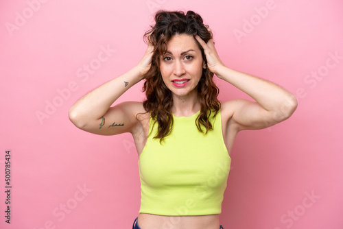 Young caucasian woman isolated on pink background doing nervous gesture © luismolinero