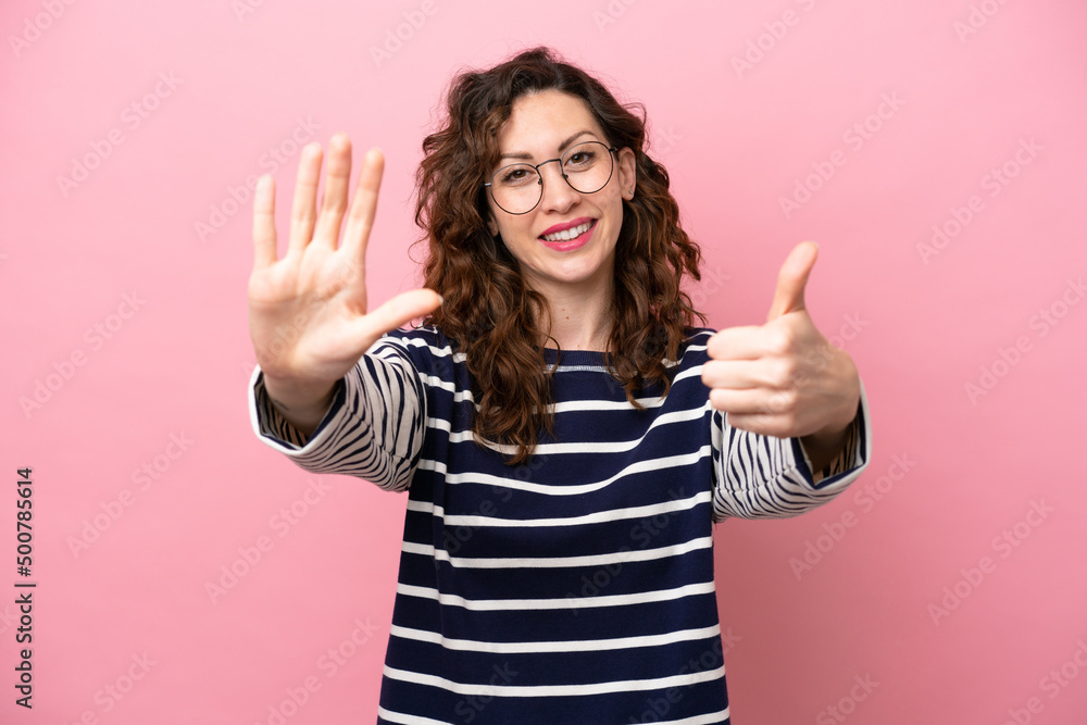 Young caucasian woman isolated on pink background counting six with fingers Young caucasian woman isolated on pink background counting six with fingers