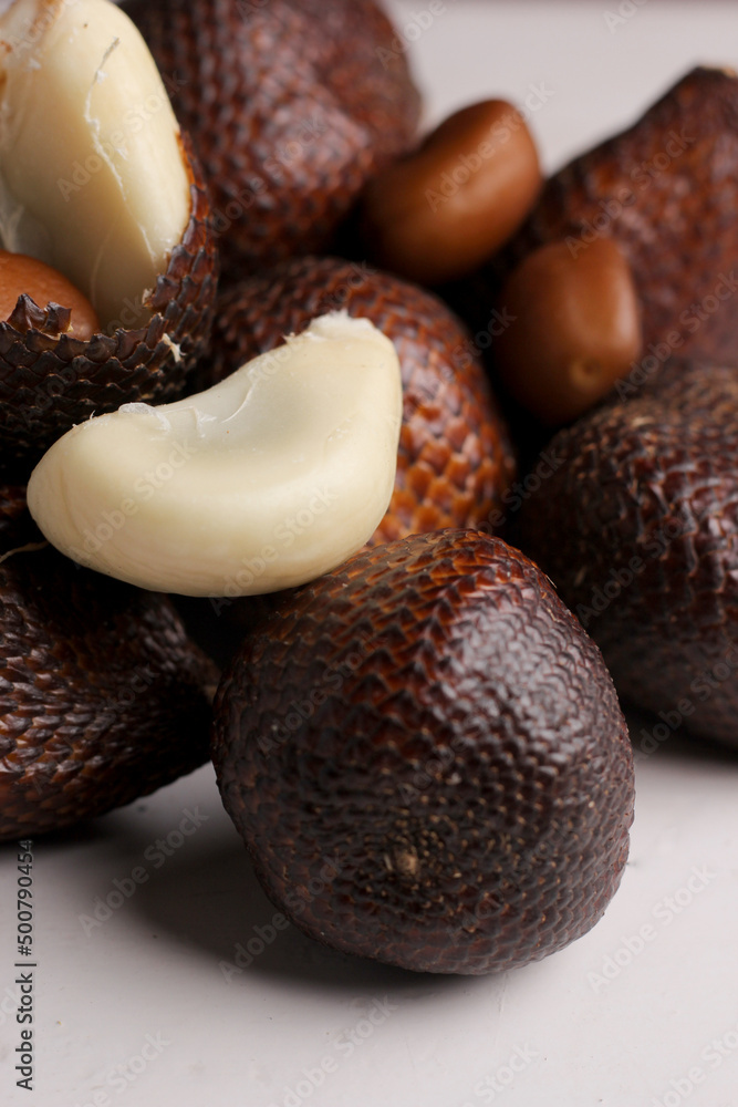 closeup, Salak seeds or snake fruit with peeled flesh isolated on a gray background closeup, Salak seeds or snake fruit with peeled flesh isolated on a gray background