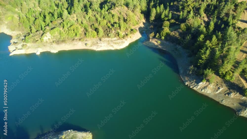 Blue lake in the Troodos mountains in the rays of the sun in the spring .Cyprus island. Aerial view.
