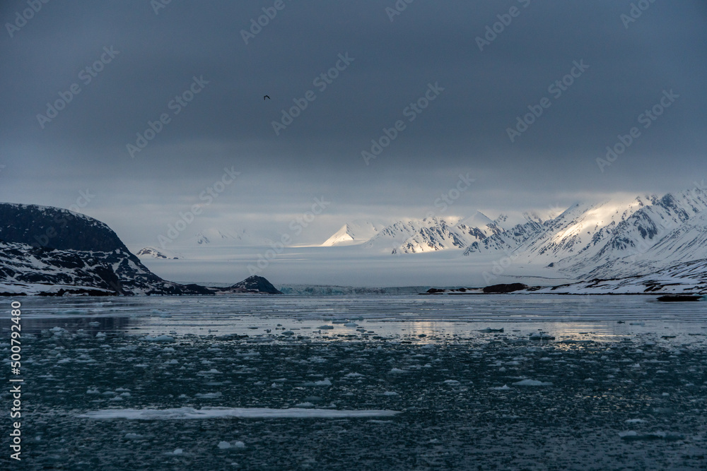 Snowy mountains with peaks in the clouds. In Svalbard, Norway. Global Warming. Snowy mountains with peaks in the clouds. In Svalbard, Norway. Global Warming.