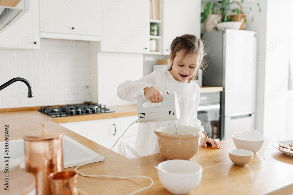Adorable girl preparing icing pancakes at the kitchen. Concept of food preparation. Casual lifestyle photo series in real life interior Adorable girl preparing icing pancakes at the kitchen. Concept of food preparation. Casual lifestyle photo series in real life interior