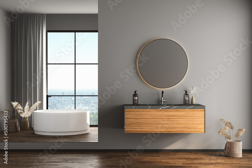 Modern bathroom interior with dark brown parquet floor, white and black bathtub and marble wash basin, front view. Minimalist bathroom with modern furniture and city view. 3D rendering
