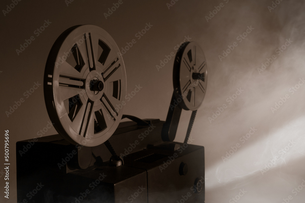 Fototapeta premium Old vintage 8mm projector with film reels and film frames. Copy space. Selective focus.