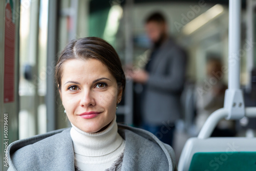 Quadro em tela Portrait of positive female passenger traveling in tram