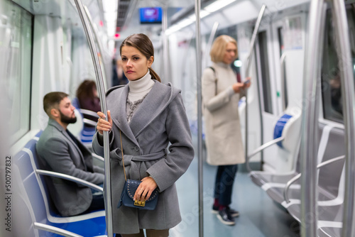 Portrait of positive female passenger traveling in tram