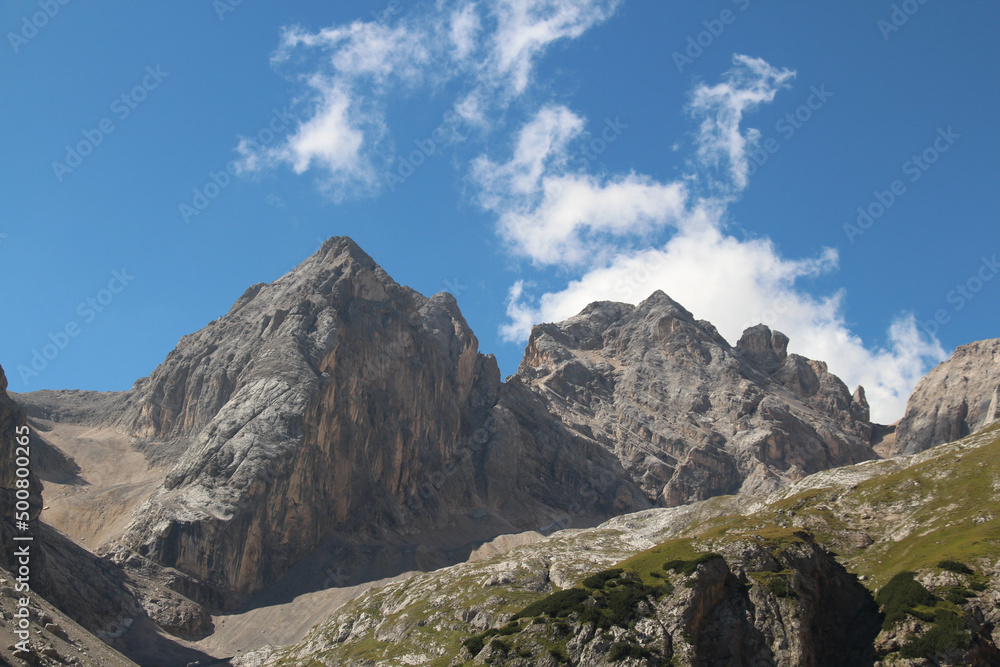 Mountain massif of Ombretta Valley in a sunny day, Italian Alps.
