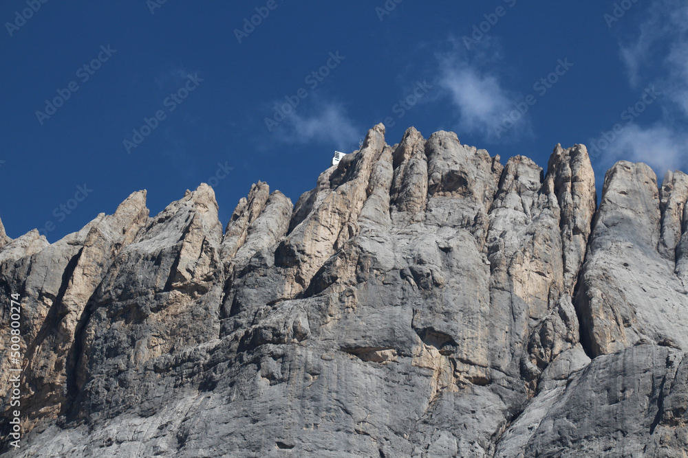 South face of Marmolada Ombretta with blue sky on background, Italian Alps.