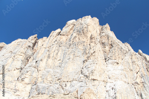 Peak of mountain massif in a sunny day with blue sky on background. Italian Alps.