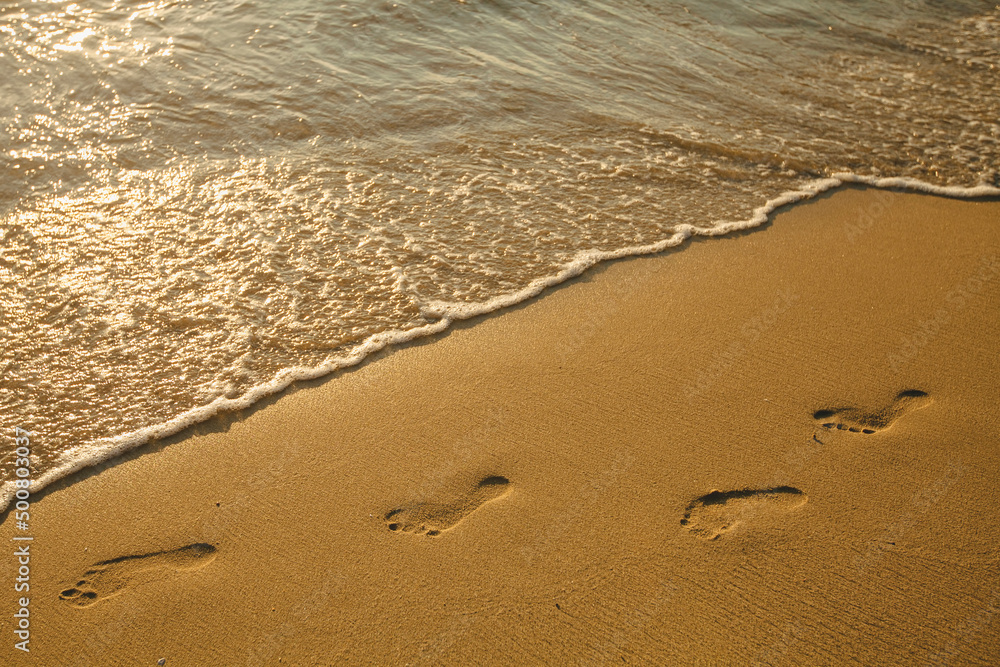 Footprints of bare feet on the beach sand. Footprints of bare feet on the beach sand.