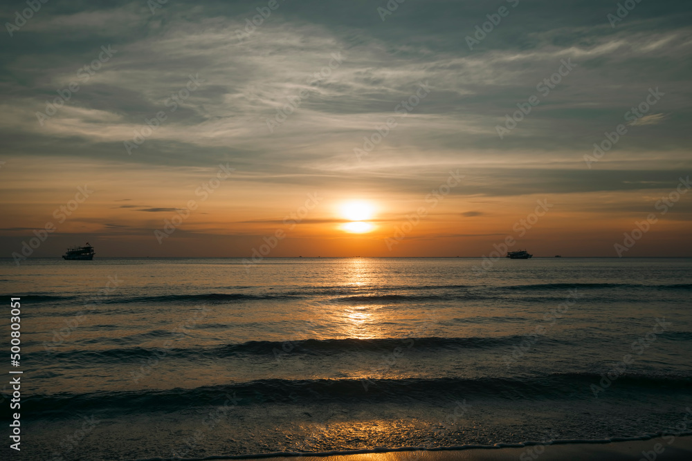 A beautiful sunset on a tropical sea beach in Thailand.