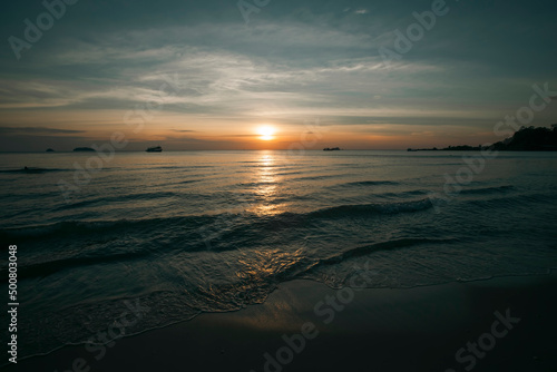 A beautiful sunset on a deserted tropical sea beach.