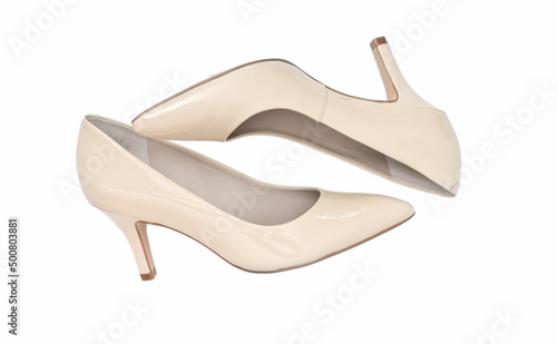 Female high heel classic shoes on white background. isolated image of beige elegant shoes. fashion blog concept