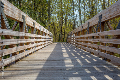 A photograph of a wooden bridge and trees background on Bud Blancher Trail near Eatonville  Washington.