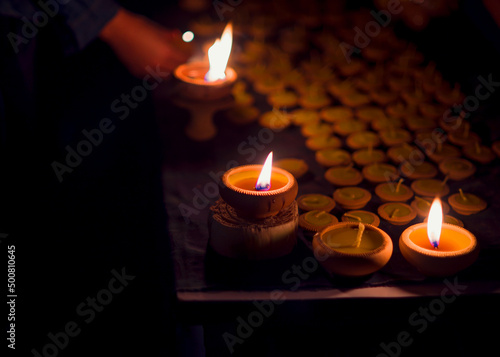 In Thailand, candles are lit on Loy Krathong Day.Burning candles on dark surface