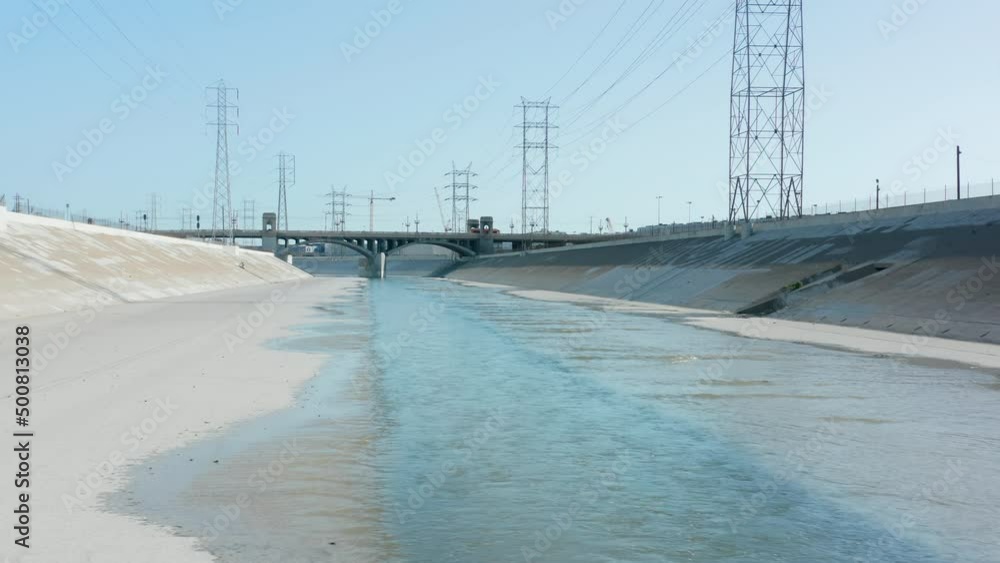 Bridges span shallow Los Angeles River, Scenic blue water flow under bridge 4K Bridges span shallow Los Angeles River, Scenic blue water flow under bridge 4K