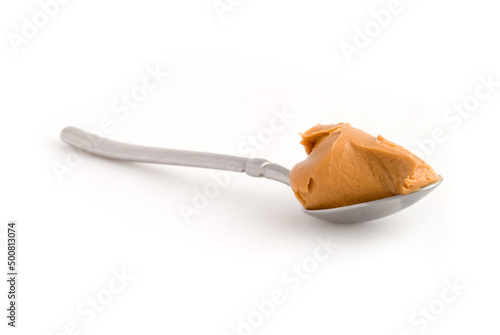 Canvas Print Scoop of peanut butter on a metal spoon isolated on white.