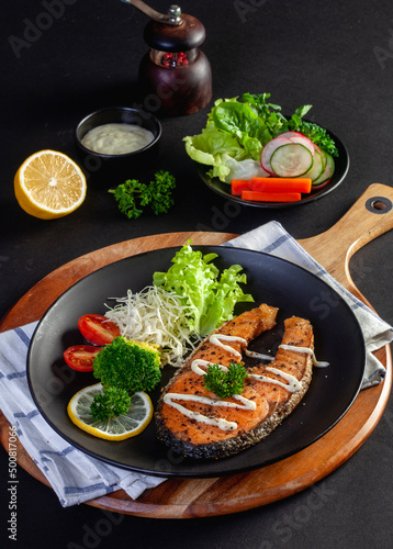 salmon steak on black background