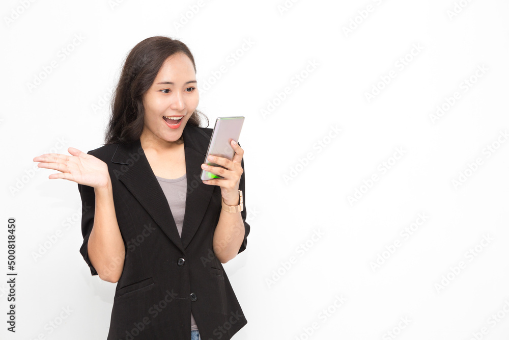 Beautiful Asian business woman wearing black suit holding smartphone on white background and copy space. Confident Asian working woman excited and cheerful Beautiful Asian business woman wearing black suit holding smartphone on white background and copy space. Confident Asian working woman excited and cheerful