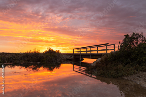 A vibrant sunrise reflecting on the Onkaparinga River in Port Noarlunga South Australia on March 4th 2022