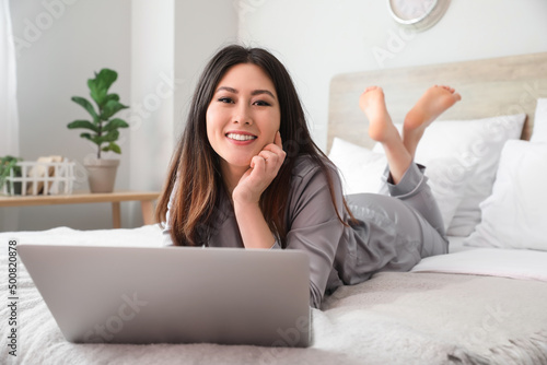 Young Asian barefoot woman ...