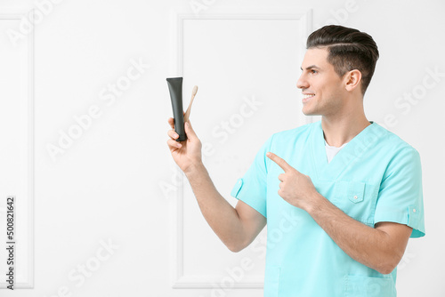 Male dentist with activated...