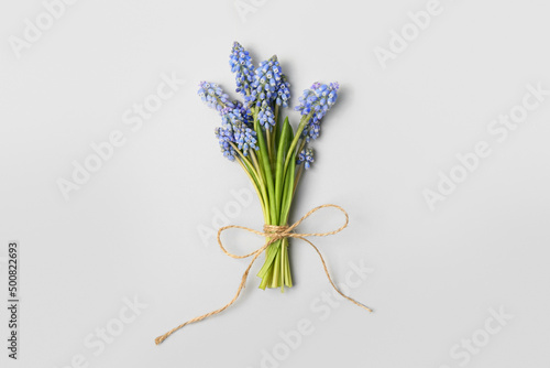 Bouquet of beautiful Muscari flowers on light background  top view