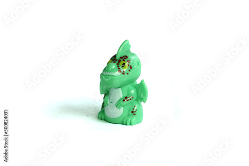 side view green dragon plastic toy isolated on white background.