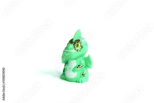 side view green dragon plastic toy isolated on white background.