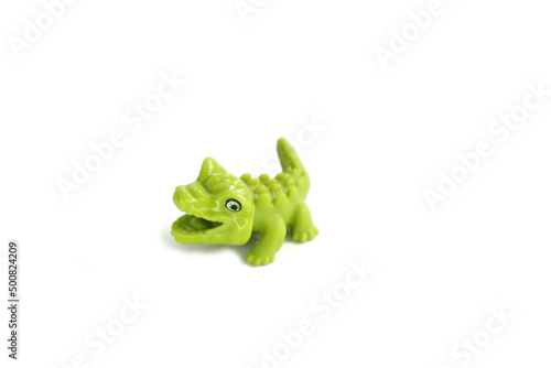 alligator, green crocodile toy made from rubber isolated on white background