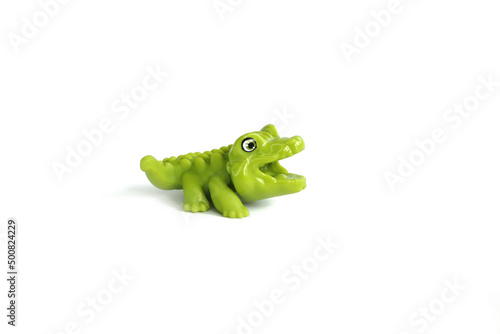 alligator, green crocodile toy made from rubber isolated on white background