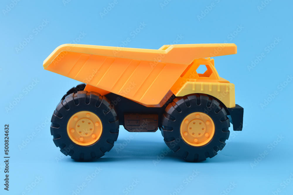 Toy loader truck isolated on a blue background Toy loader truck isolated on a blue background