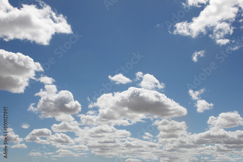 A view of the blue sky featuring clouds in a bushy or patchy design.