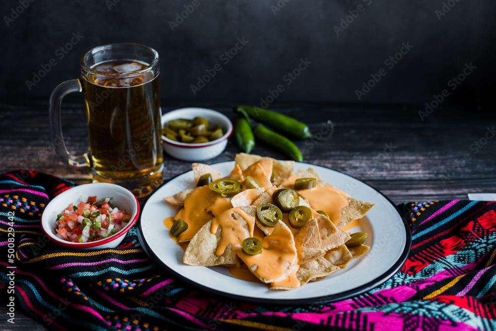 Mexican nachos chips with american cheese, beer and jalapeños in Mexico Latin America Mexican nachos chips with american cheese, beer and jalapeños in Mexico Latin America